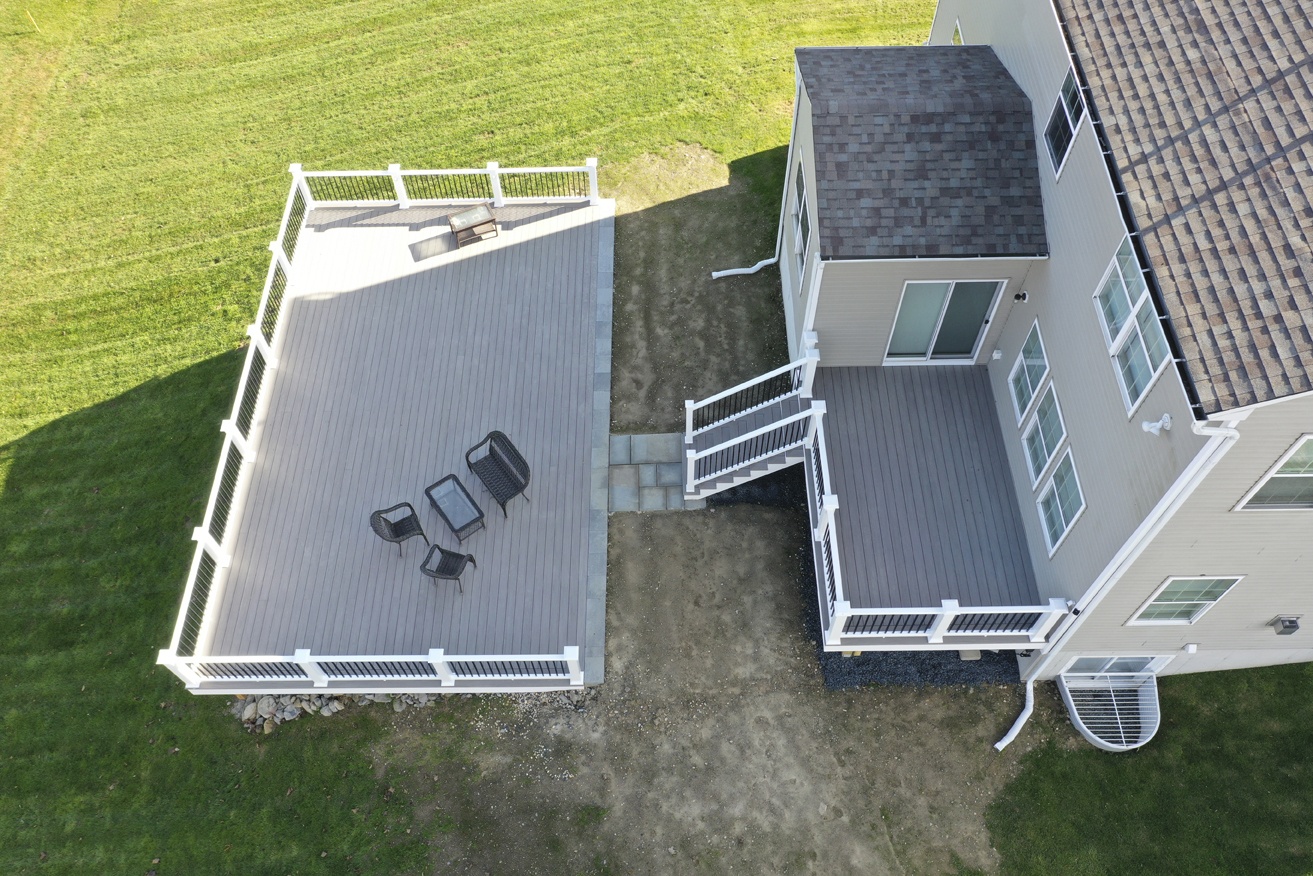 aerial view of newly remodeled deck on large hill overlooking tree grove