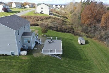 aerial view of newly remodeled deck on large hill overlooking tree grove