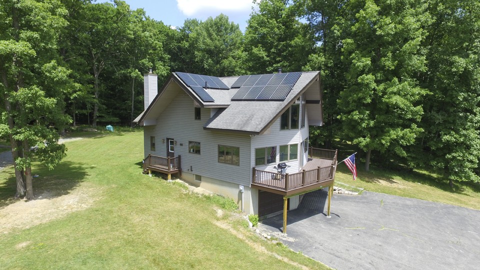 side view of custom deck at remote cabin with solar panels