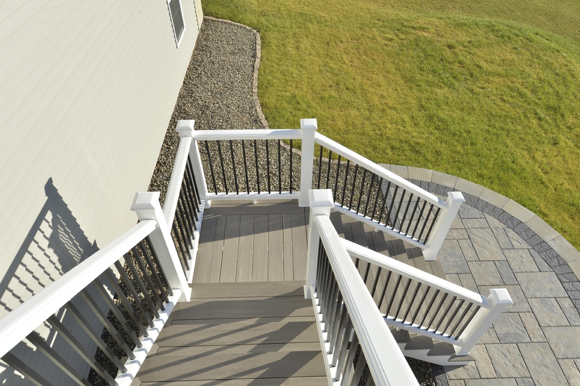 2-story stairs with white railing and taupe decking material
