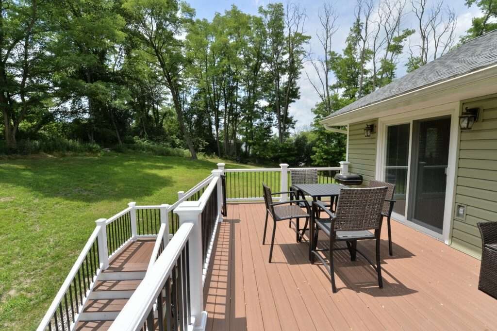 Table and Chairs on deck with white railing