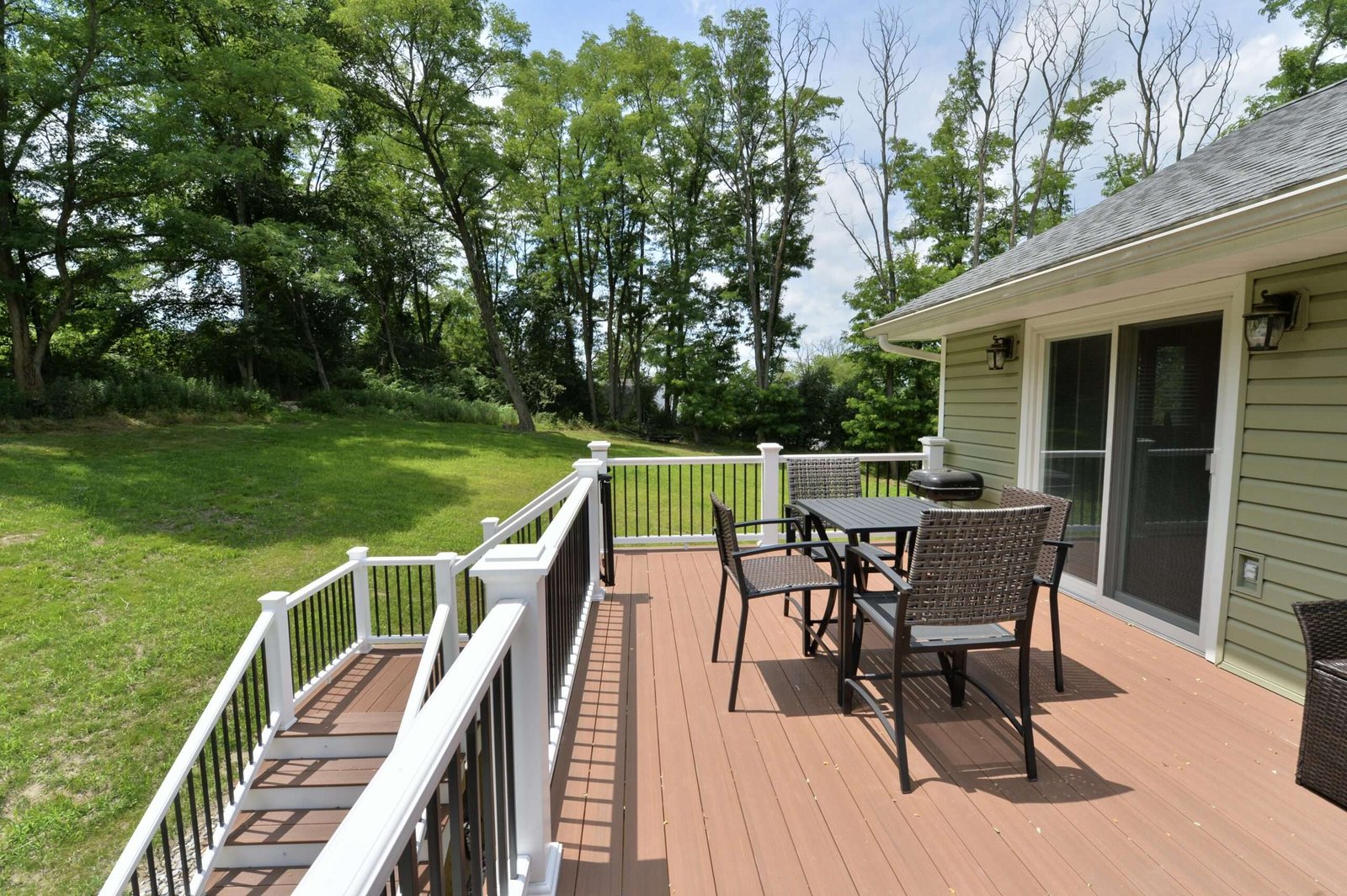Table and Chairs on deck with white railing