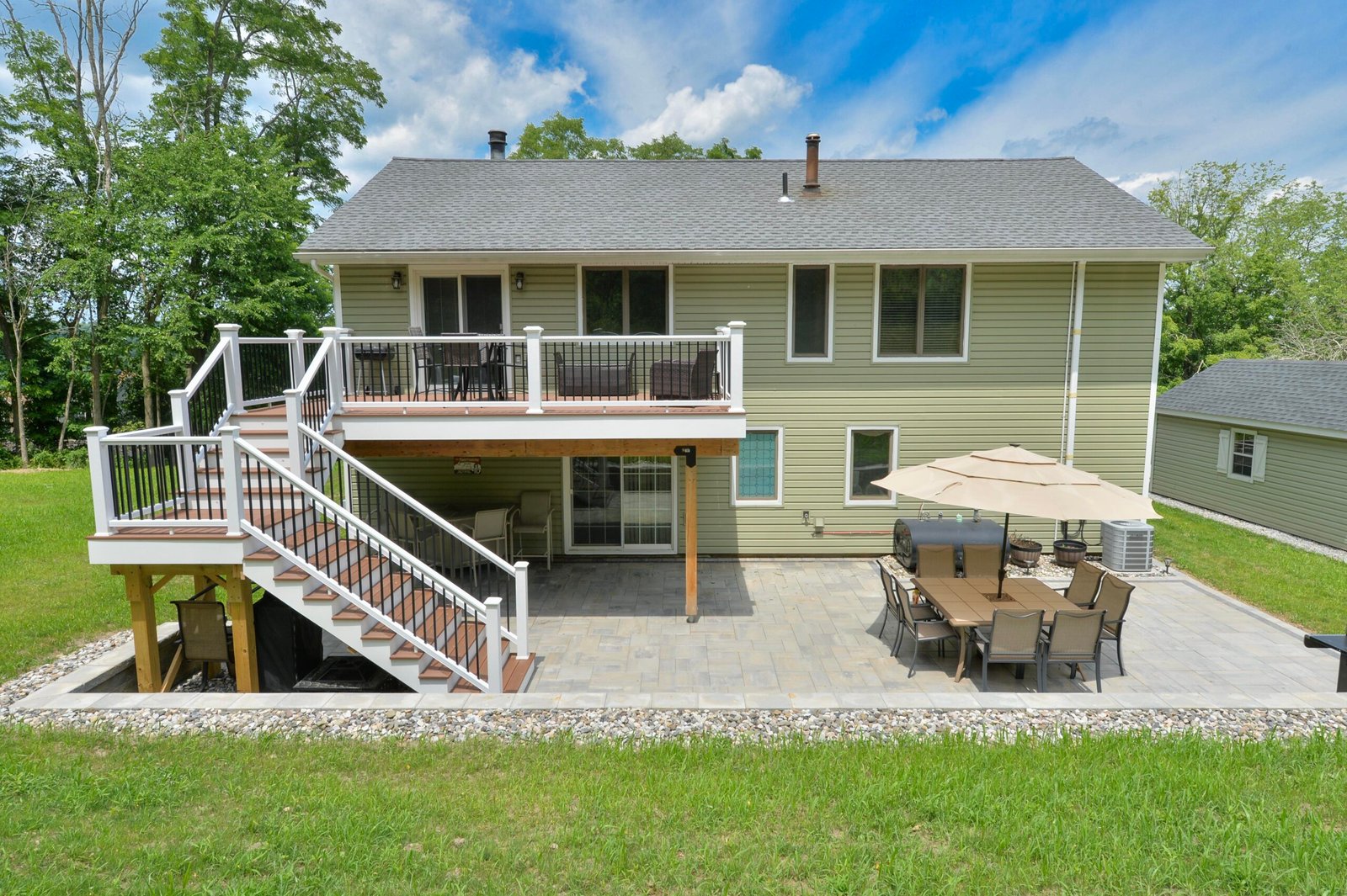 Featured Image - back facade of home with two story deck in the hudson valley