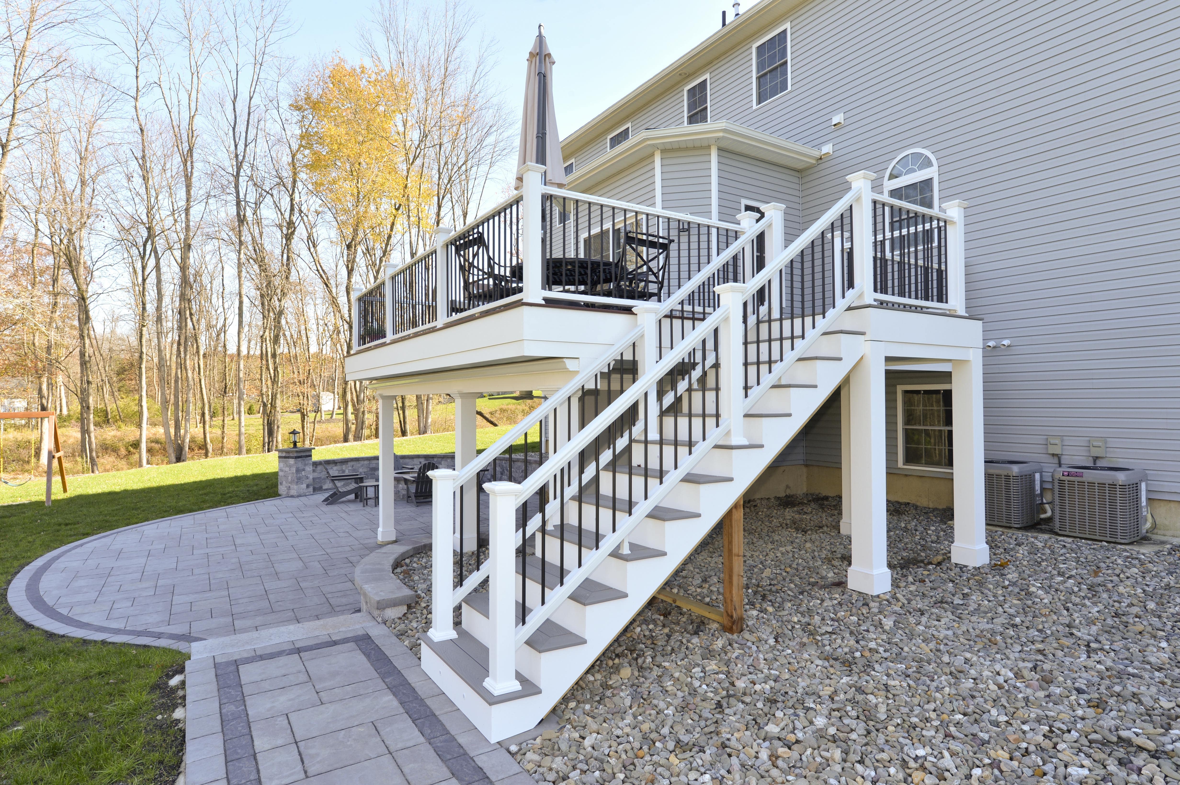 side view of stairs for two story custom deck and hardscaping