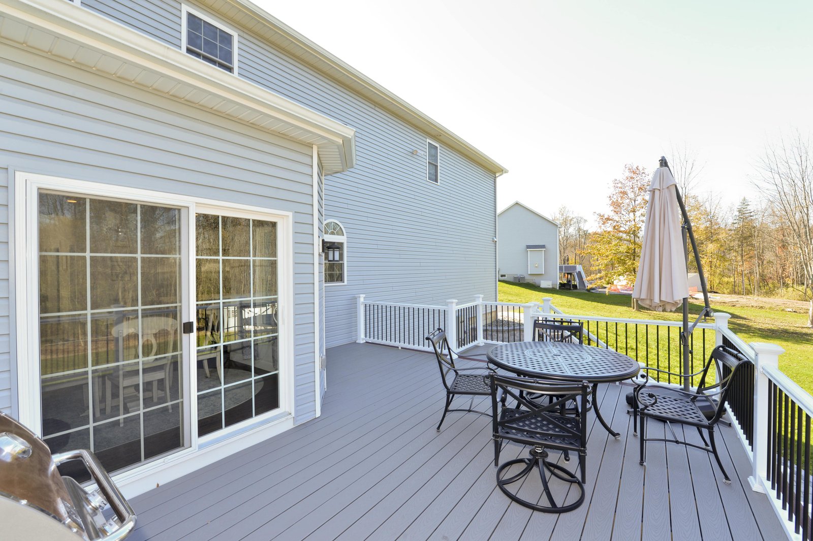 second story custom deck with french doors and outdoor eating space